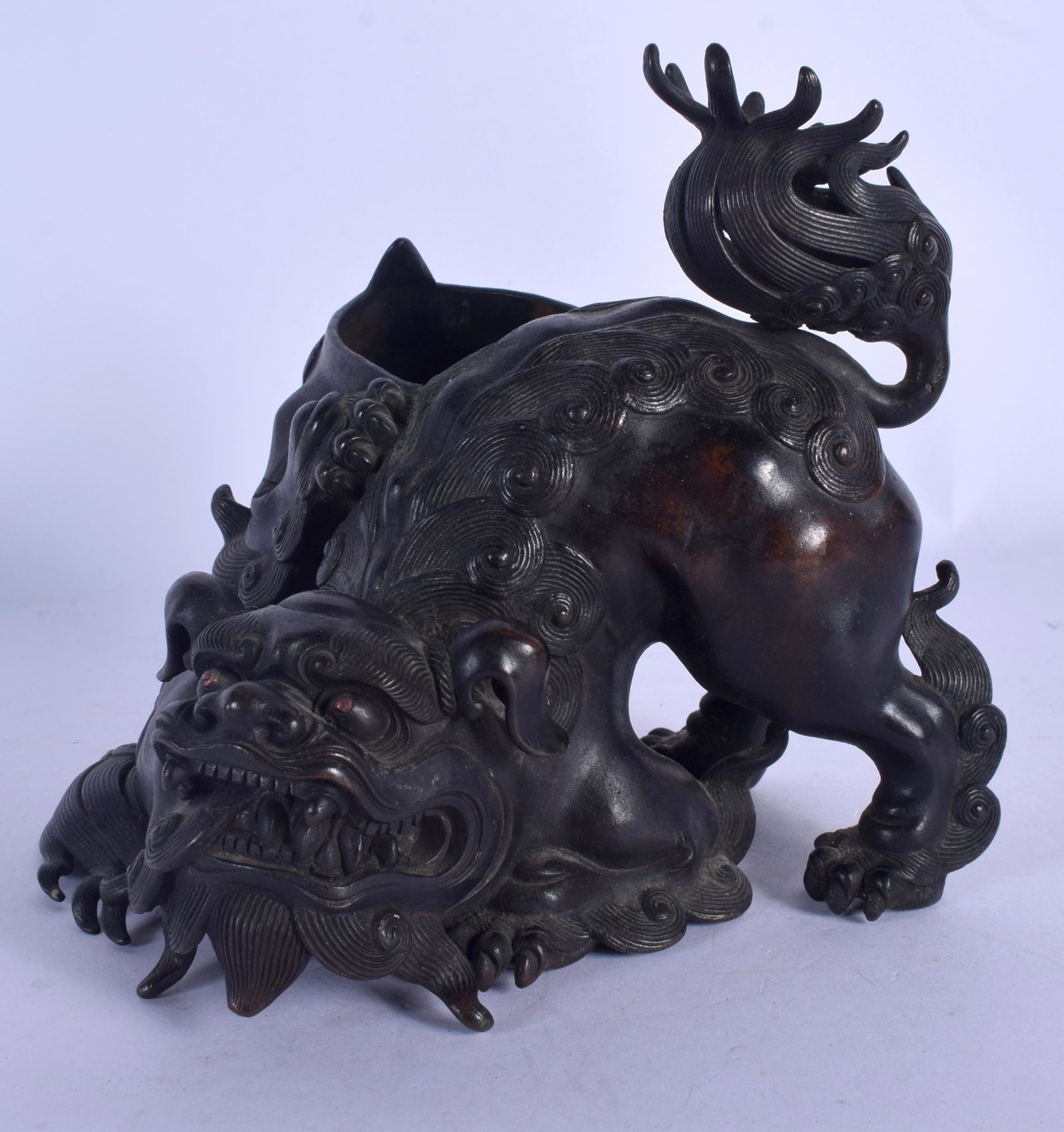 AN 18TH CENTURY JAPANESE EDO PERIOD BRONZE BUDDHISTIC: AN 18TH CENTURY JAPANESE EDO PERIOD BRONZE BUDDHISTIC LION modelled scowling. 14 cm x 12 cm.