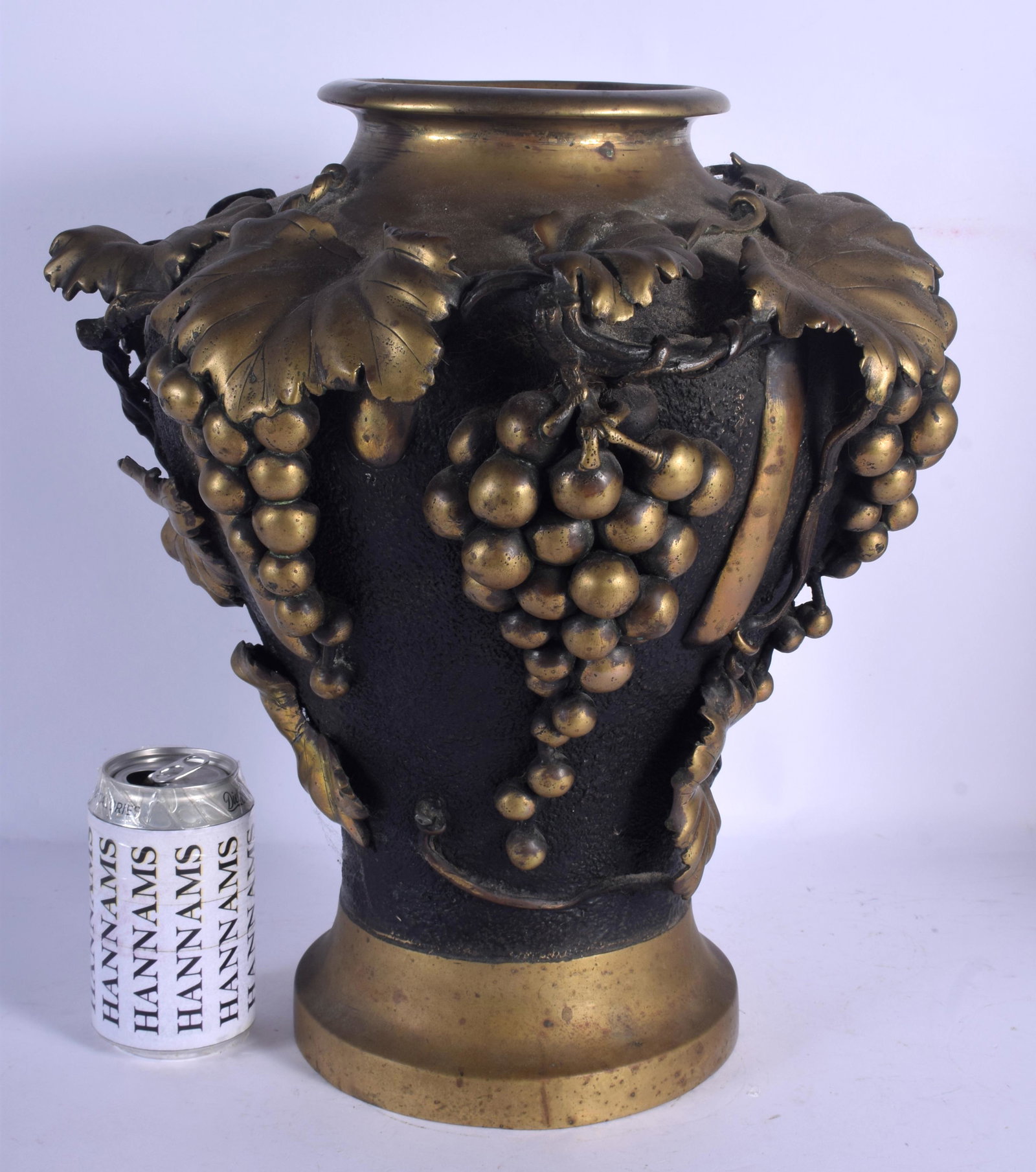A LARGE 19TH CENTURY JAPANESE MEIJI PERIOD BRONZE VASE: A LARGE 19TH CENTURY JAPANESE MEIJI PERIOD BRONZE VASE overlaid with berries and vines. 38 cm x 28 cm.