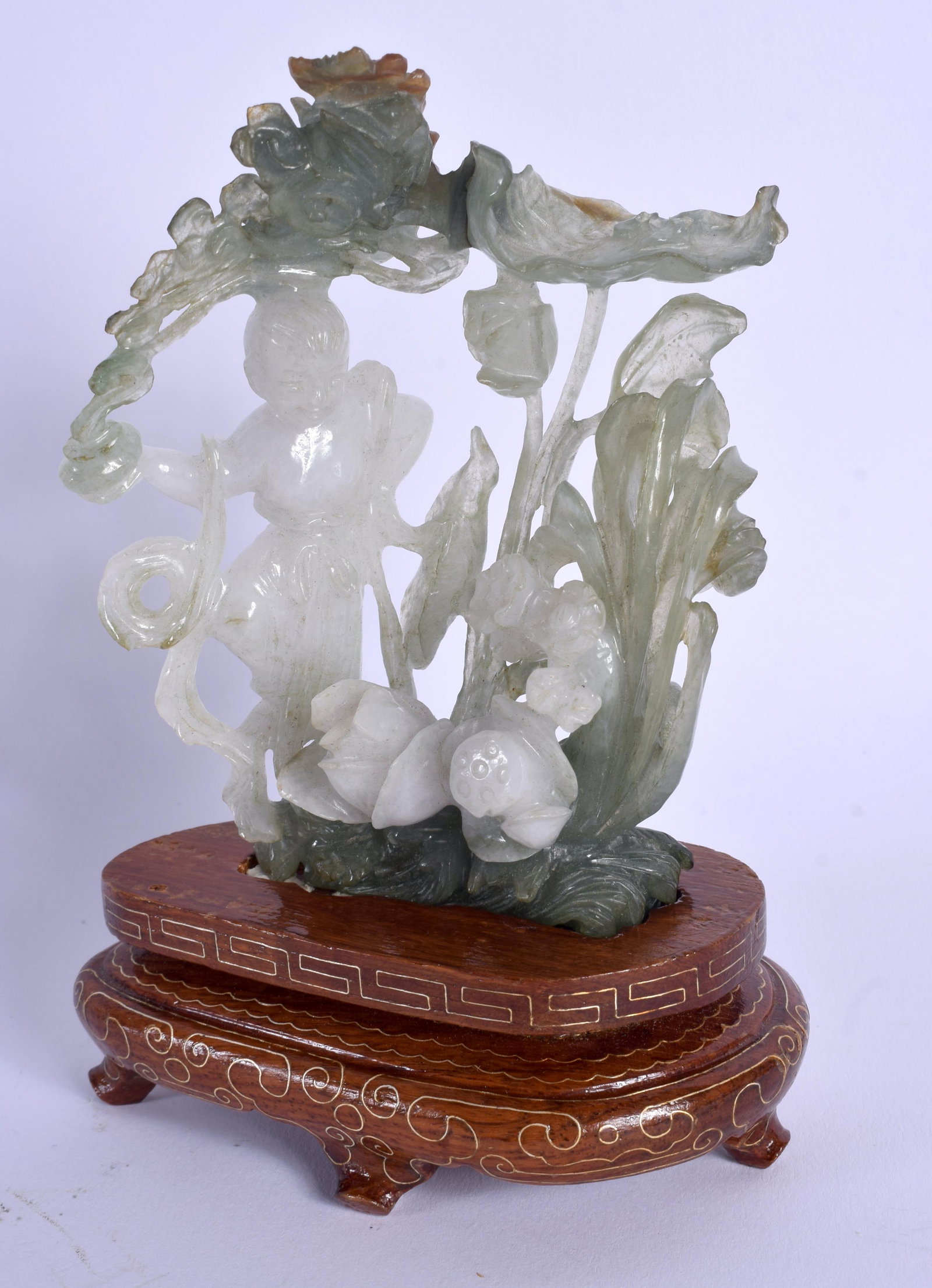 AN EARLY 20TH CENTURY CHINESE CARVED JADEITE FIGURE OF: AN EARLY 20TH CENTURY CHINESE CARVED JADEITE FIGURE OF A FEMALE modelled amongst foliage. Jadeite 12 cm x 7 cm.