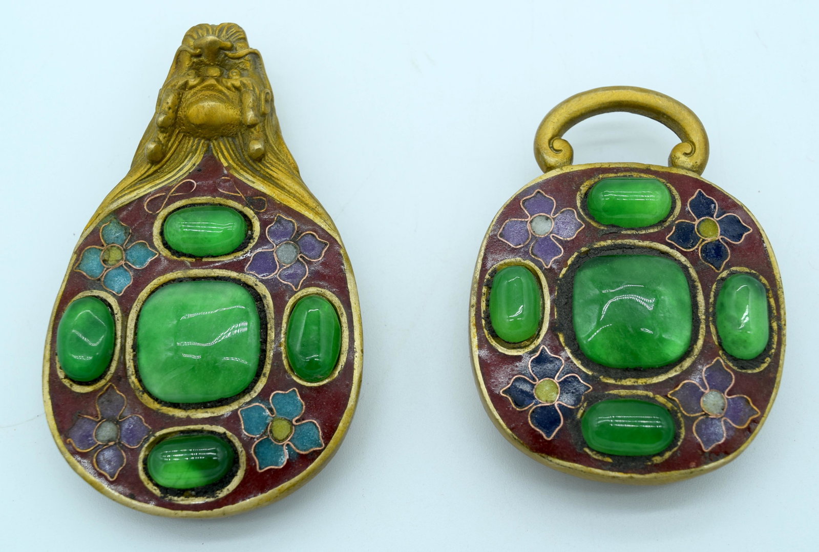 A Chinese bronze belt buckle with enamelling and glass: A Chinese bronze belt buckle with enamelling and glass stones 16cm (2).