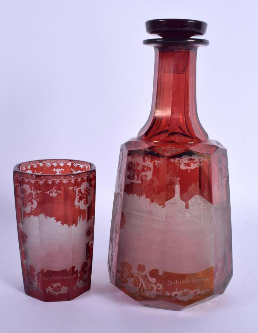 A 19TH CENTURY BOHEMIAN RUBY GLASS DECANTER AND STOPPER: A 19TH CENTURY BOHEMIAN RUBY GLASS DECANTER AND STOPPER together with a similar beaker. 24 cm high. (2)