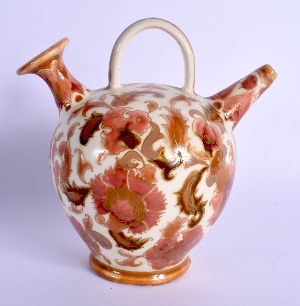 AN ANTIQUE HUNGARIAN ZSOLNAY PECS POTTERY EWER painted: AN ANTIQUE HUNGARIAN ZSOLNAY PECS POTTERY EWER painted with flowers. 13 cm x 11 cm.