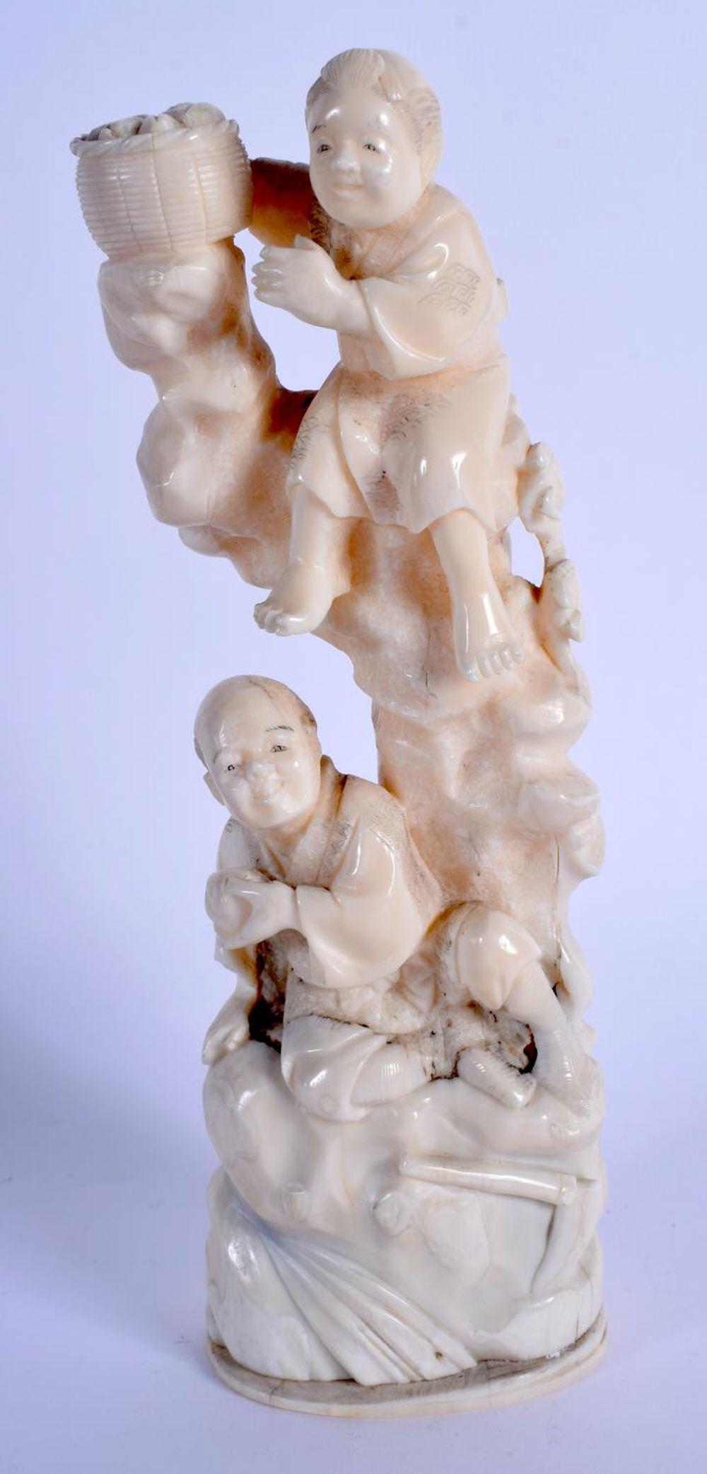 A 19TH CENTURY JAPANESE MEIJI PERIOD CARVED BONE: A 19TH CENTURY JAPANESE MEIJI PERIOD CARVED BONE OKIMONO modelled as a male and a child. 20.5 cm high.