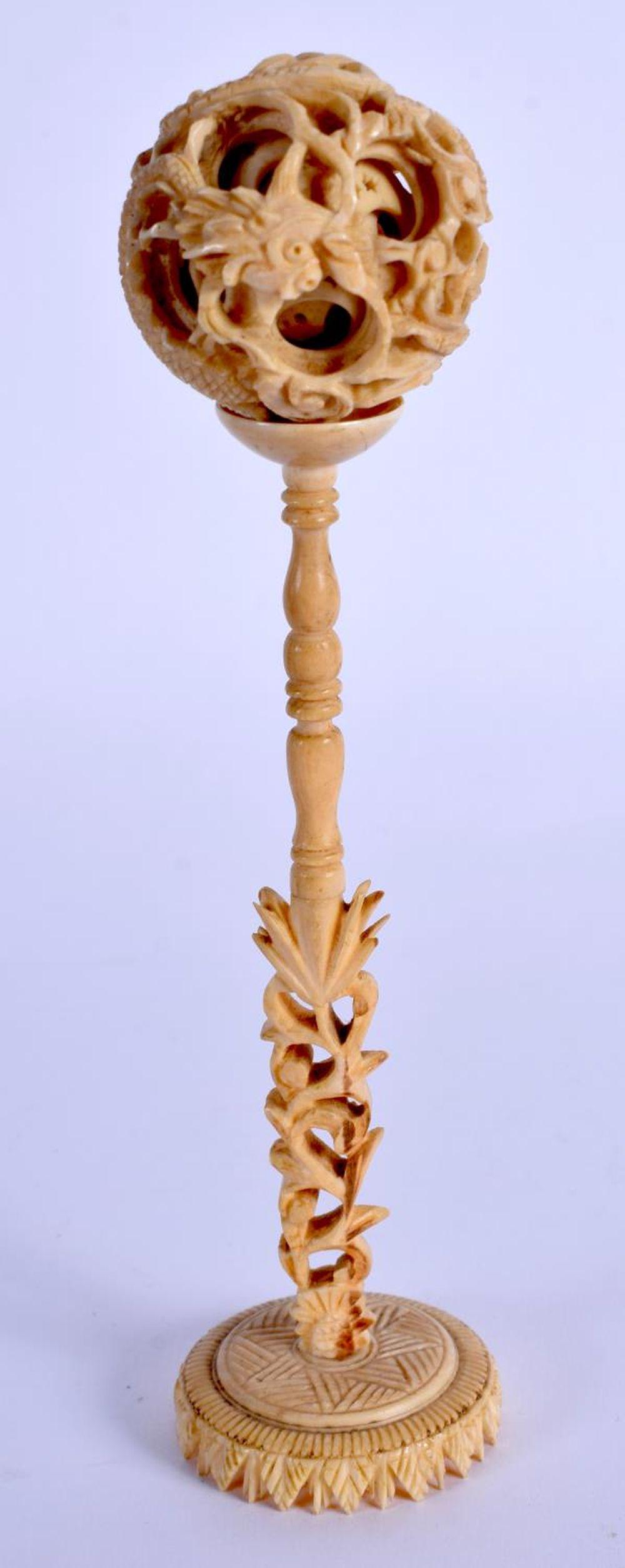 A 19TH CENTURY CHINESE CARVED CANTON BONE PUZZLE BALL: A 19TH CENTURY CHINESE CARVED CANTON BONE PUZZLE BALL ON STAND. 15 cm x 3 cm.
