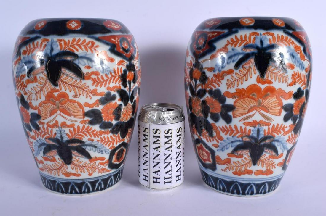A PAIR OF 19TH CENTURY JAPANESE MEIJI PERIOD IMARI: A PAIR OF 19TH CENTURY JAPANESE MEIJI PERIOD IMARI PORCELAIN VASES painted with foliage and insects. 24 cm x 12 cm.