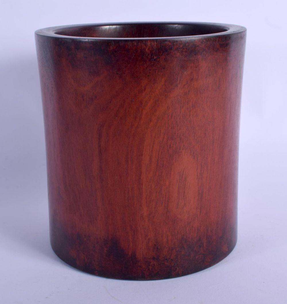 A CHINESE QING DYNASTY CARVED HARDWOOD BRUSH POT: A CHINESE QING DYNASTY CARVED HARDWOOD BRUSH POT Bitong, of plain form. 17 cm x 11 cm.