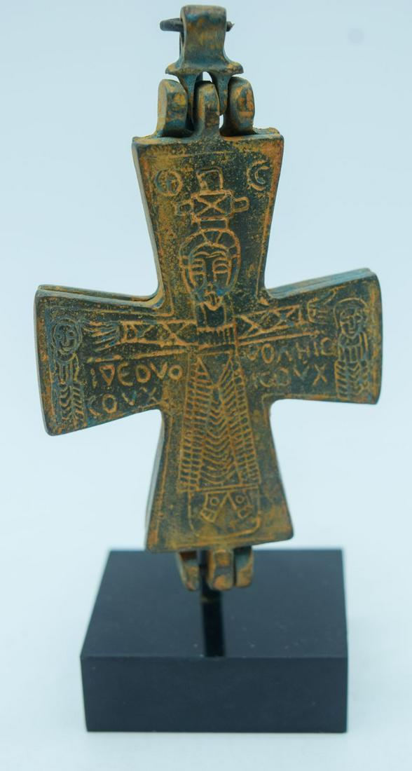 A Byzantine bronze cross on a stand 11cm.: A Byzantine bronze cross on a stand 11cm.