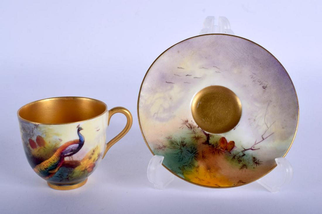 Royal Worcester coffee cup and saucer painted with a: Royal Worcester coffee cup and saucer painted with a Peacock by R. Austin, cup signed, date mark 1926. Cup 5m high and Saucer 10cm diameter