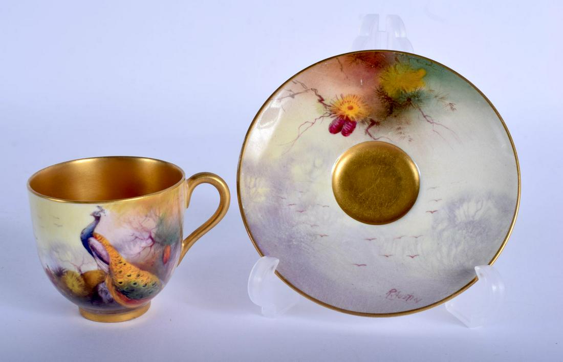 Royal Worcester coffee cup and saucer painted with a: Royal Worcester coffee cup and saucer painted with a Peacock by R. Austin, signed, date mark 1930. Cup 5cm high and Saucer 10cm diameter