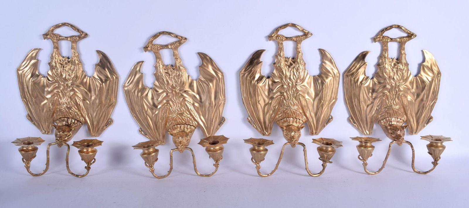 A RARE SET OF FOUR CONTEMPORARY GILT BRONZE BAT WALL: A RARE SET OF FOUR CONTEMPORARY GILT BRONZE BAT WALL SCONCES modelled holding branches in its mouth. 32 cm x 20 cm. (4)