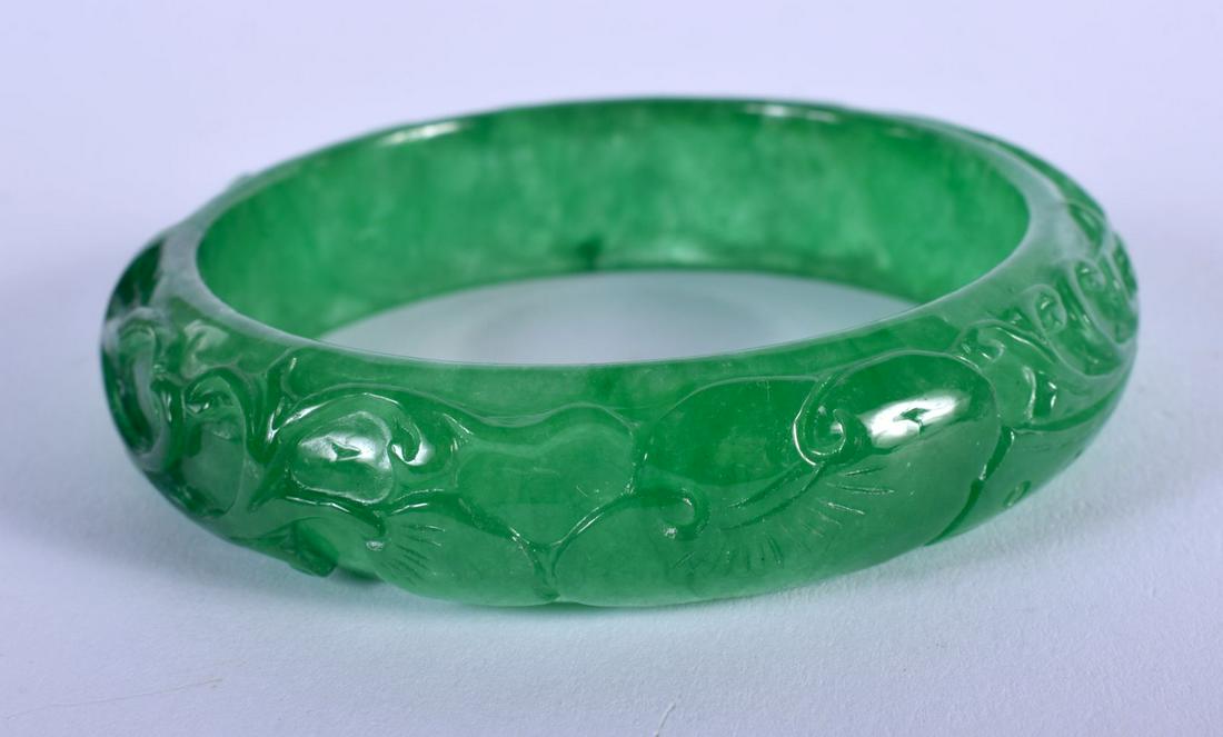 A CHINESE CARVED SPINACH JADE BANGLE 20th Century. 6.5 (1 of 3)