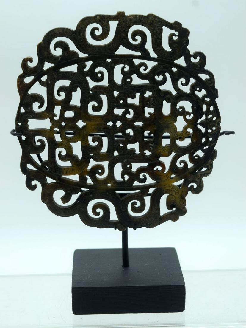 A carved Chinese hardstone plaque on a stand decorated (1 of 3)