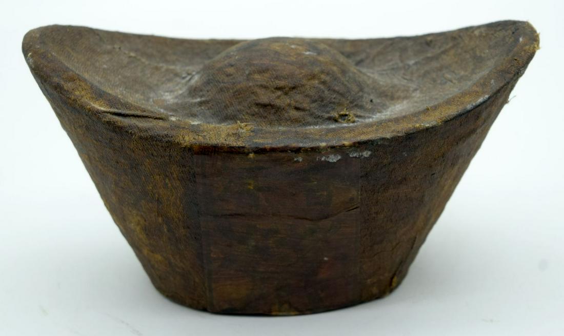 A Chinese compressed Tea block in the form of an ingot (1 of 4)