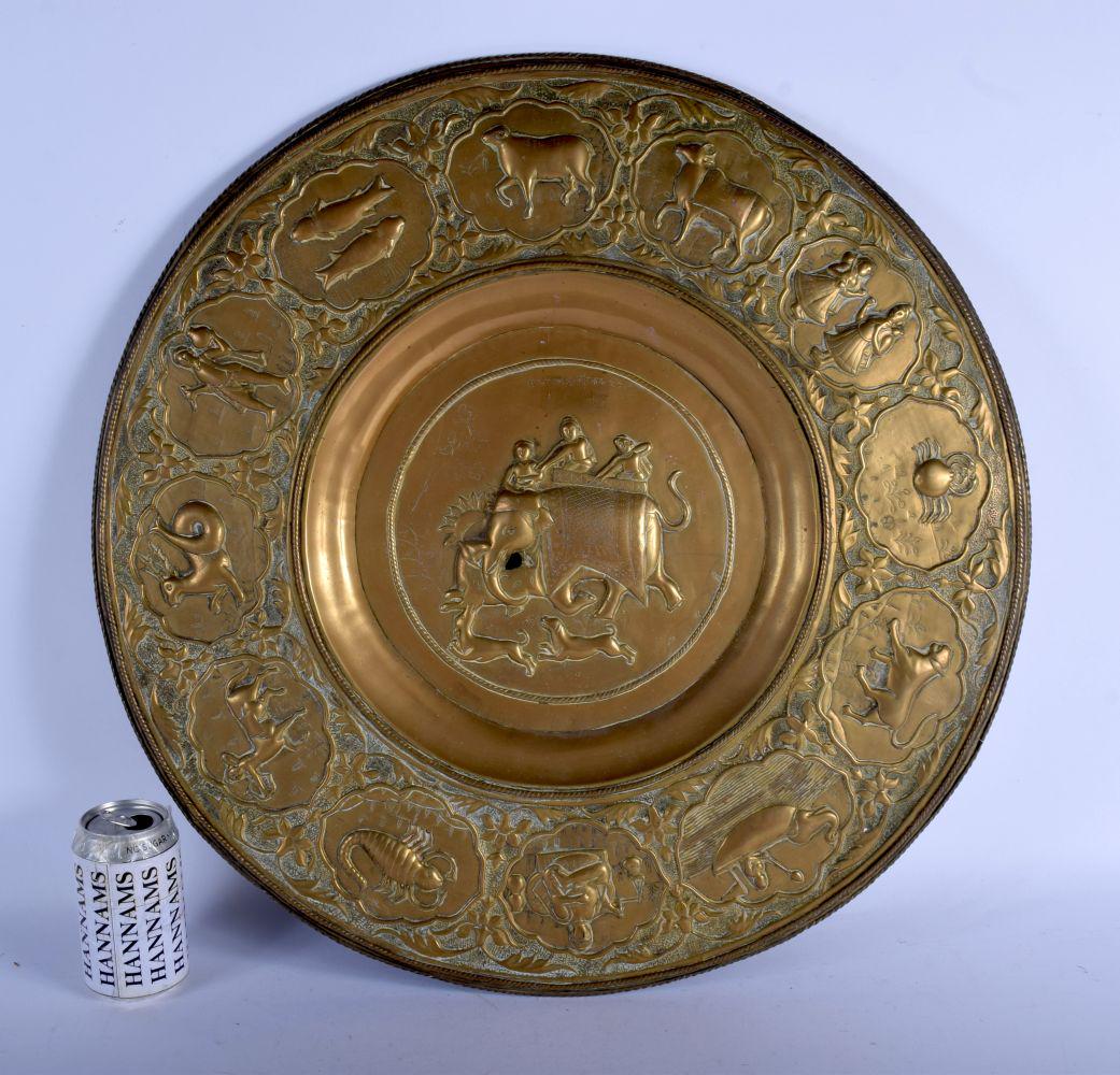 A LARGE 19TH CENTURY INDIAN BRASS EMBOSSED CHARGER (1 of 5)