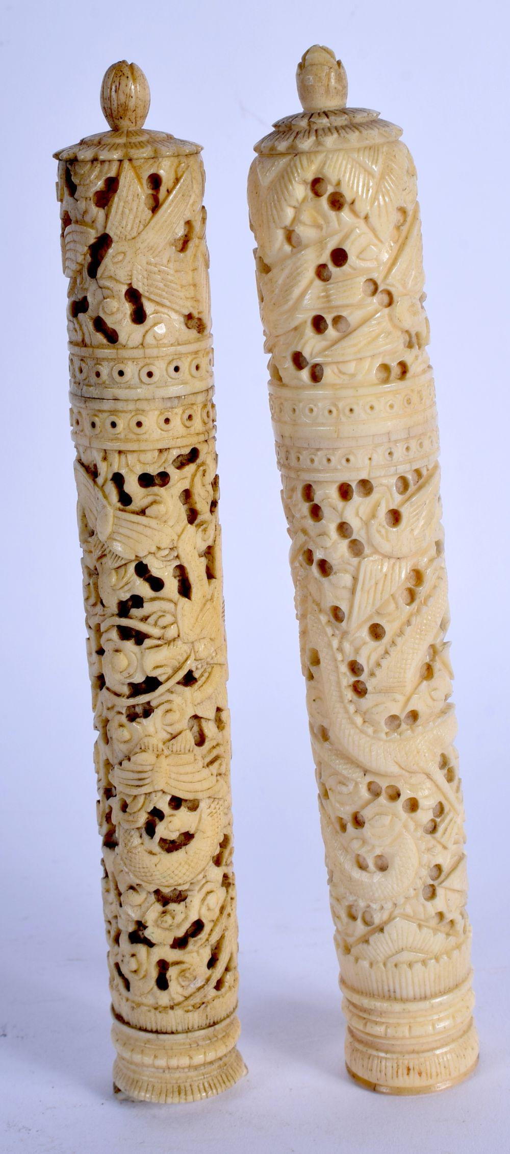 A NEAR PAIR OF 19TH CENTURY CHINESE CANTON IVORY NEEDLE: A NEAR PAIR OF 19TH CENTURY CHINESE CANTON IVORY NEEDLE CASES AND COVERS Qing, carved with dragons and birds. 15.5 cm long.