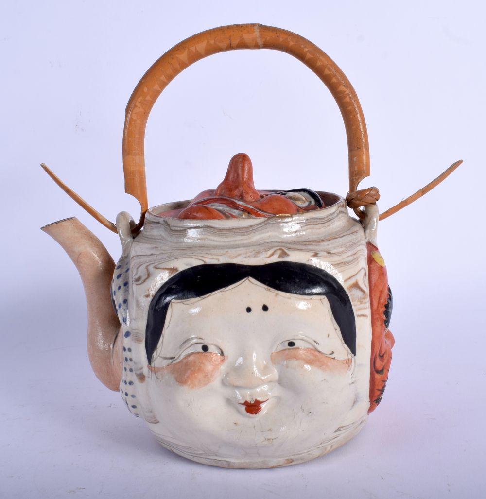 A RARE EARLY 20TH CENTURY JAPANESE MEIJI PERIOD: A RARE EARLY 20TH CENTURY JAPANESE MEIJI PERIOD PORCELAIN MASK TEAPOT AND COVER of amusing form. 21 cm x 11 cm inc handle.