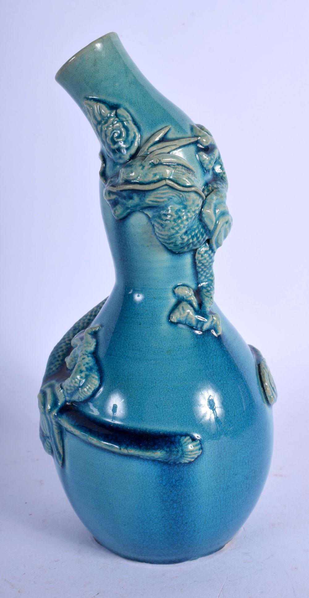A 19TH CENTURY JAPANESE MEIJI PERIOD BLUE GLAZED GOURD: A 19TH CENTURY JAPANESE MEIJI PERIOD BLUE GLAZED GOURD VASE overlaid with dragons. 20 cm high.