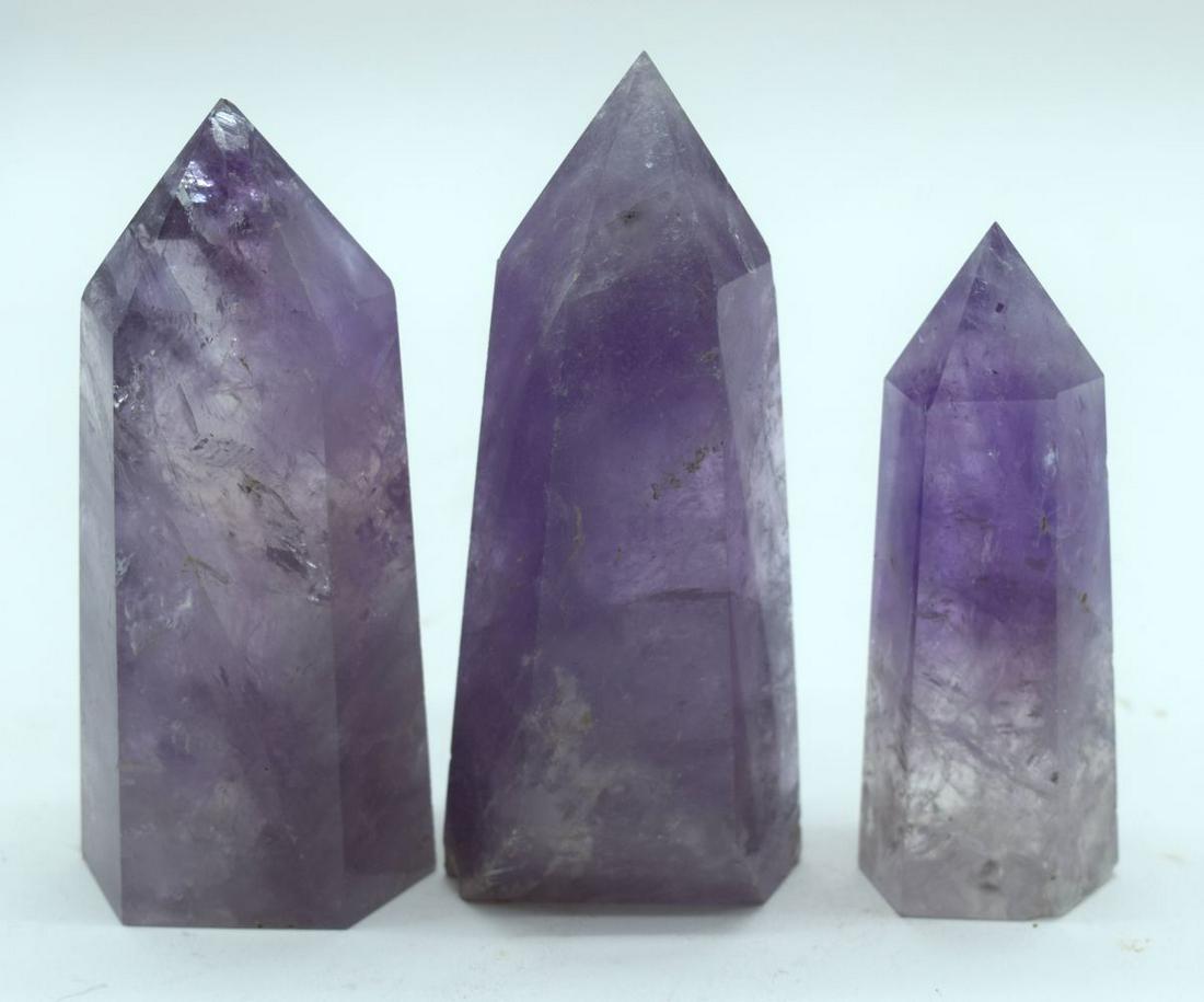 A collection of Amethyst carved Obelisks 10.5cm (3).: A collection of Amethyst carved Obelisks 10.5cm (3).