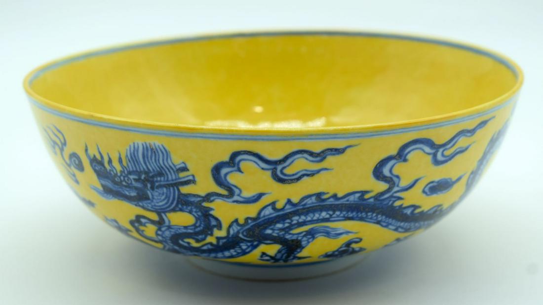 A Chinese yellow ground porcelain bowl decorated with: A Chinese yellow ground porcelain bowl decorated with dragons 21 x 8cm.
