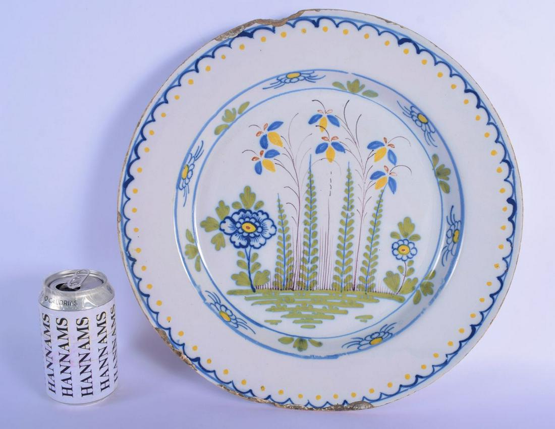 A LARGE MID 18TH CENTURY BRISTOL DELFT POLYCHROMED TIN: A LARGE MID 18TH CENTURY BRISTOL DELFT POLYCHROMED TIN GLAZED DISH painted with floral sprays. 32 cm diameter.