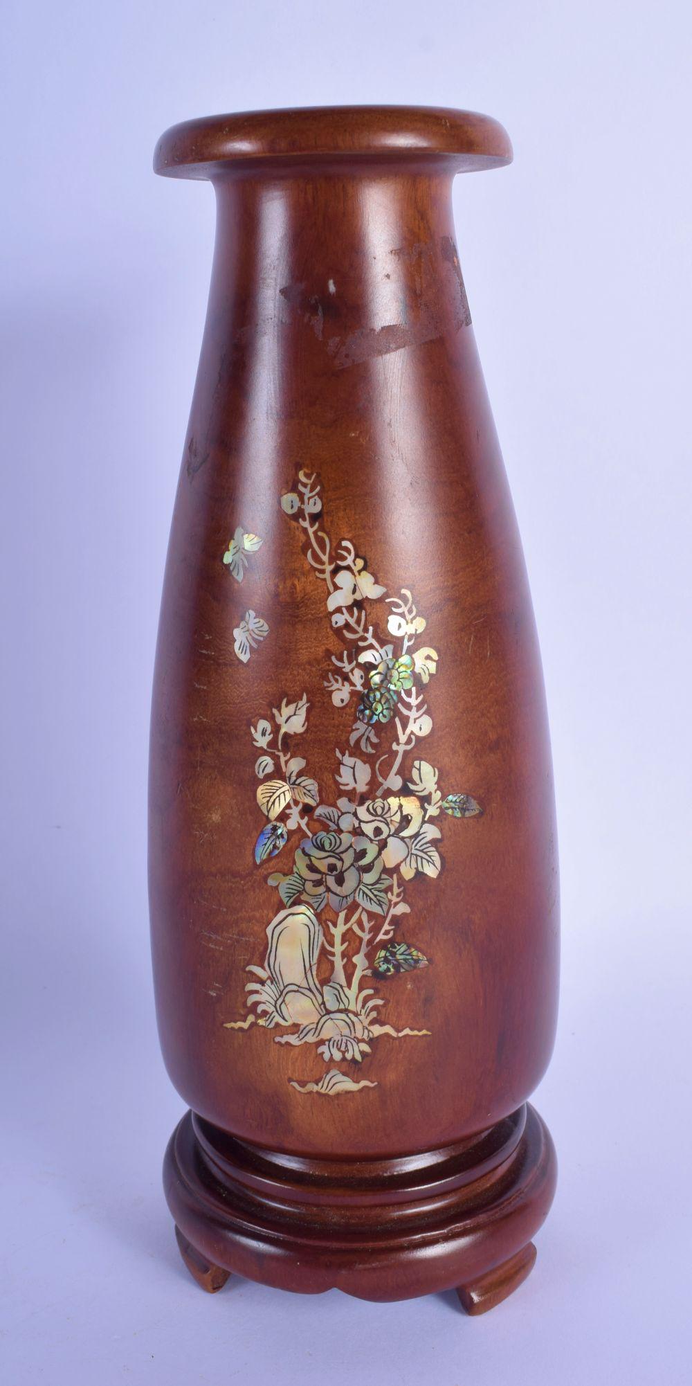 AN EARLY 20TH CENTURY CHINESE HARDWOOD MOTHER OF PEARL: AN EARLY 20TH CENTURY CHINESE HARDWOOD MOTHER OF PEARL VASE inlaid with mother of pearl foliage. 27 cm high.
