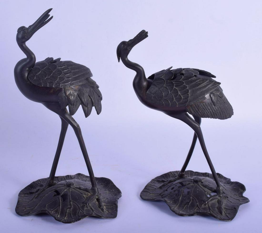A PAIR OF JAPANESE TAISHO PERIOD PATINATED METAL BIRD: A PAIR OF JAPANESE TAISHO PERIOD PATINATED METAL BIRD CENSERS AND COVERS upon a lotus base. 28 cm high.