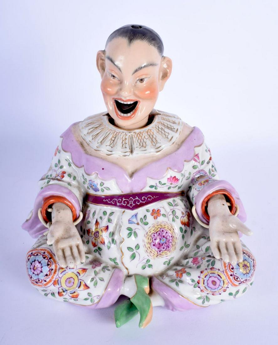 A 19TH CENTURY DRESDEN PORCELAIN NODDING FIGURE OF A: A 19TH CENTURY DRESDEN PORCELAIN NODDING FIGURE OF A CHINAMAN Meissen style, painted with flowers and vines. 18 cm x 12 cm.