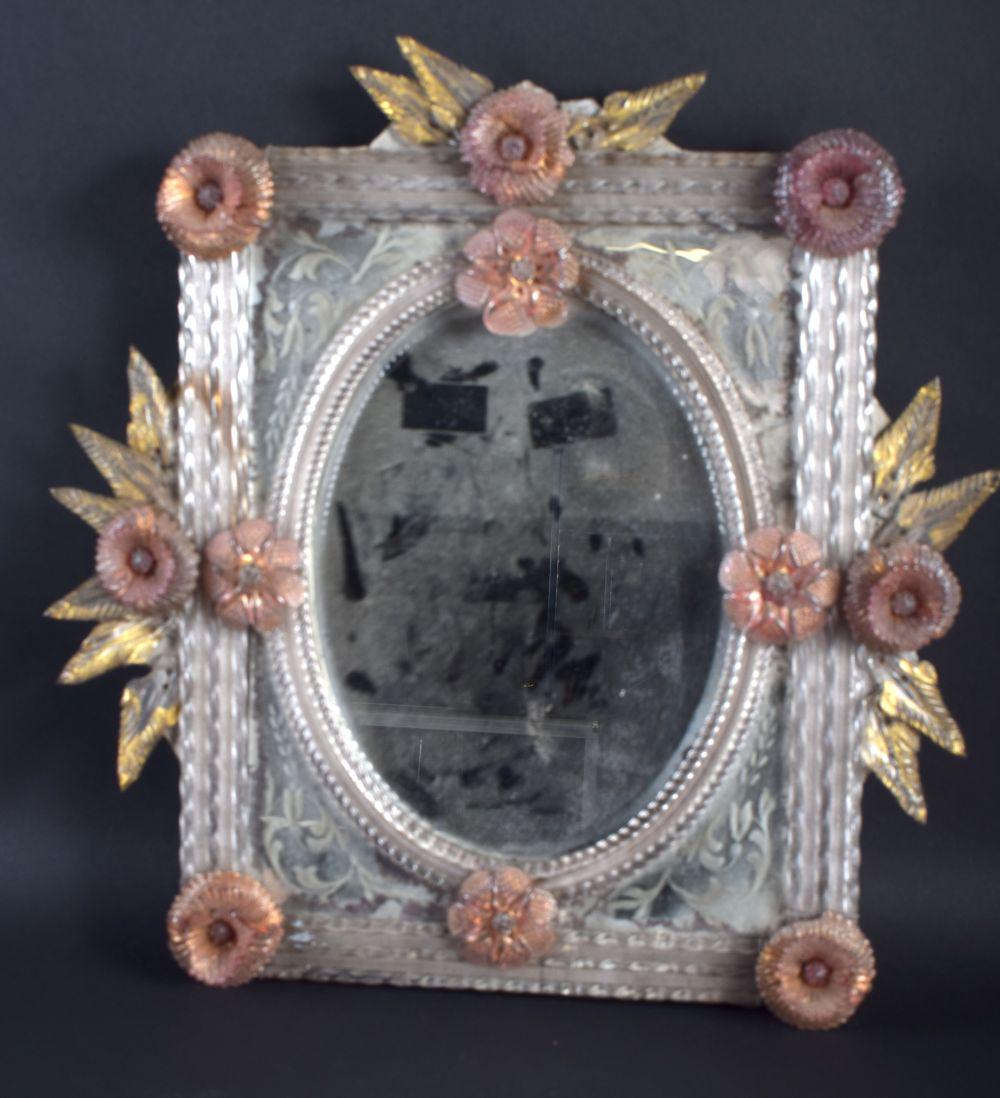 AN ANTIQUE VENETIAN GLASS MIRROR overlaid with foliage: AN ANTIQUE VENETIAN GLASS MIRROR overlaid with foliage and vines. 40 cm x 36 cm.
