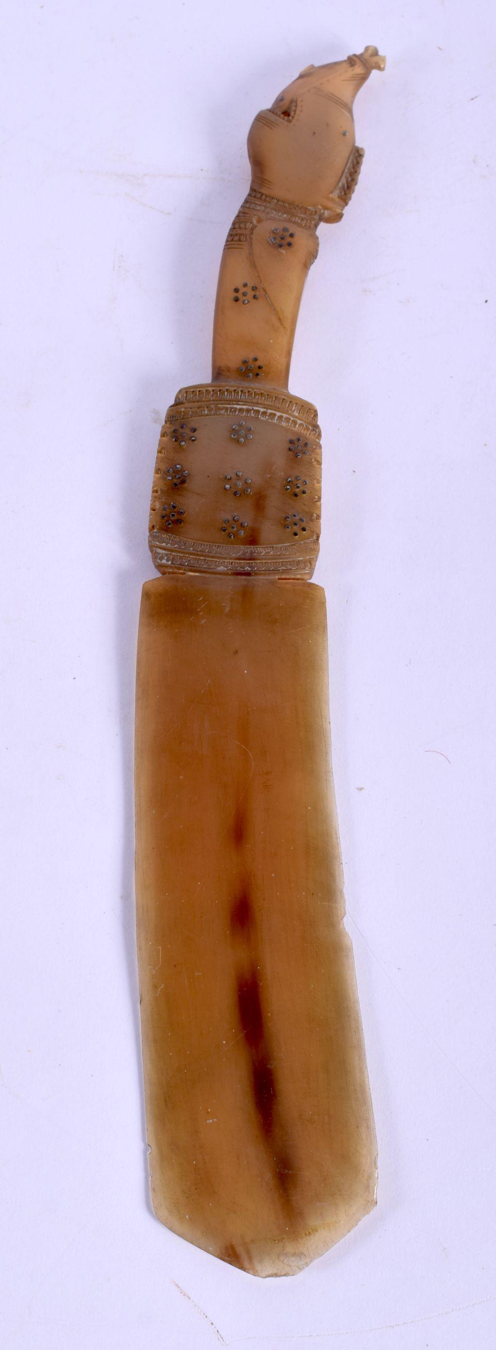 A 19TH CENTURY MIDDLE EASTERN ISLAMIC CARVED RHINOCEROS (1 of 3)