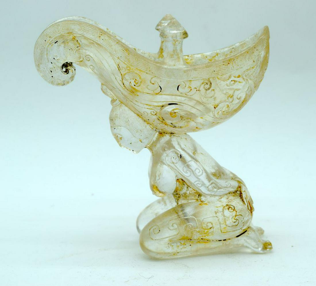 A Chinese glass Libation cup in the form of a female: A Chinese glass Libation cup in the form of a female slave. 14cm x 14cm.