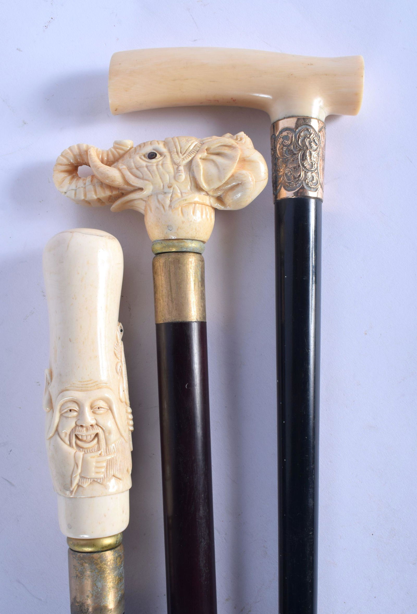 AN ANTIQUE IVORY HANDLED WALKING CANE together with two (1 of 3)