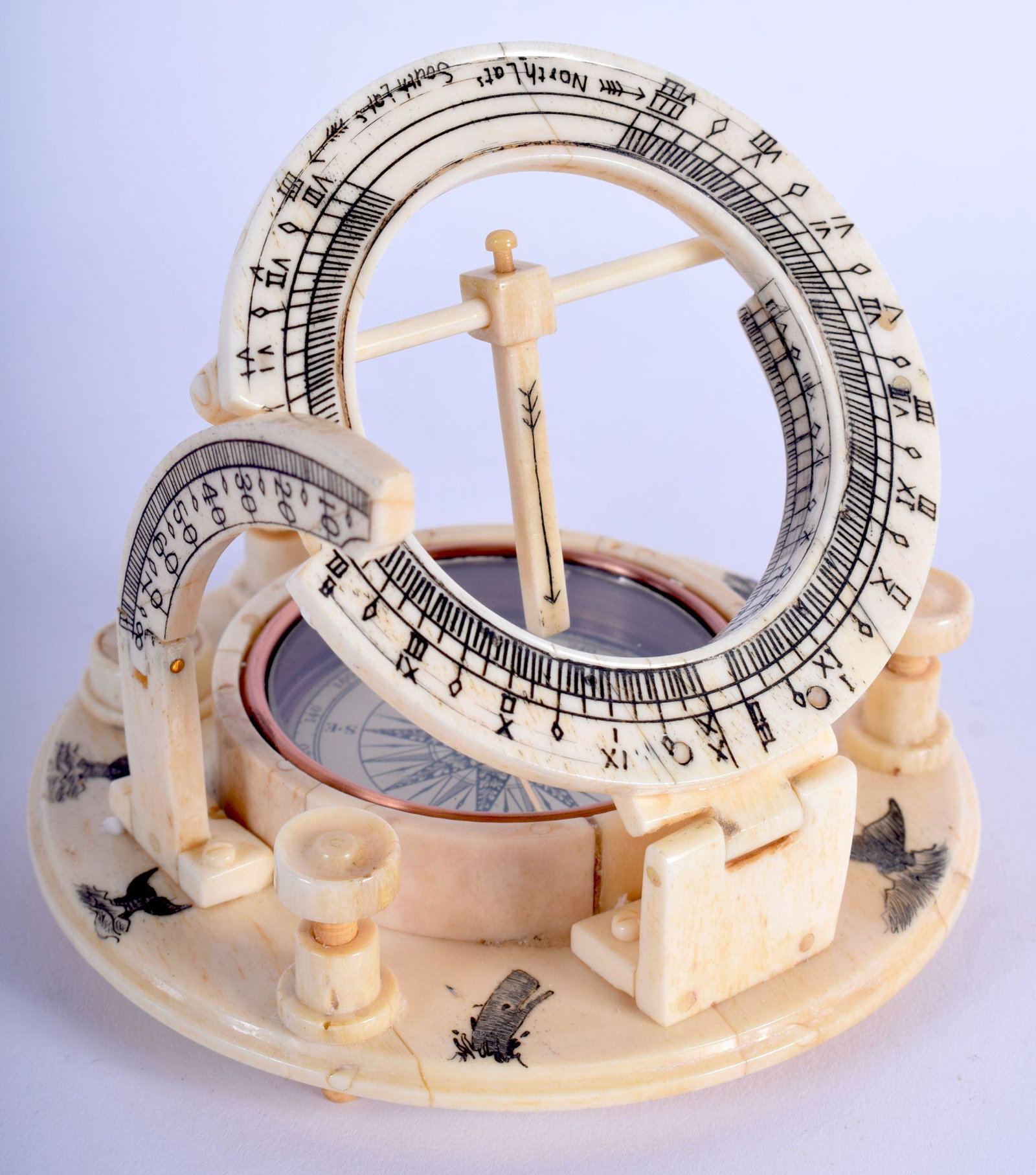A CARVED BONE MARITIME COMPASS DECORATED WITH: A CARVED BONE MARITIME COMPASS DECORATED WITH SCRIMSHAW. 11cm diameter, 4cm high