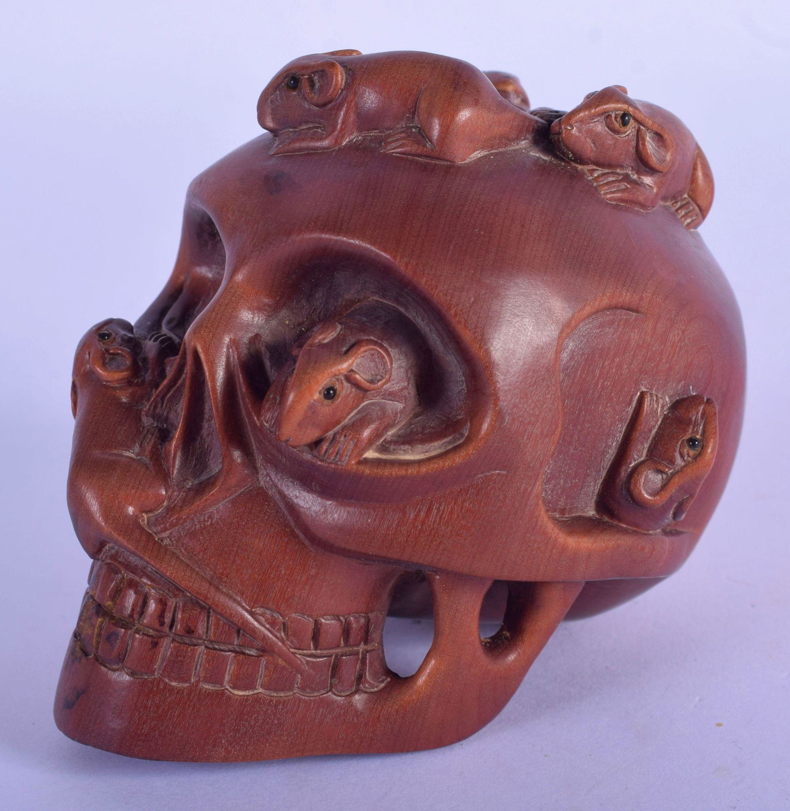 A JAPANESE WOOD SKULL CARVED WITH RATS AND A SNAKE. (1 of 3)