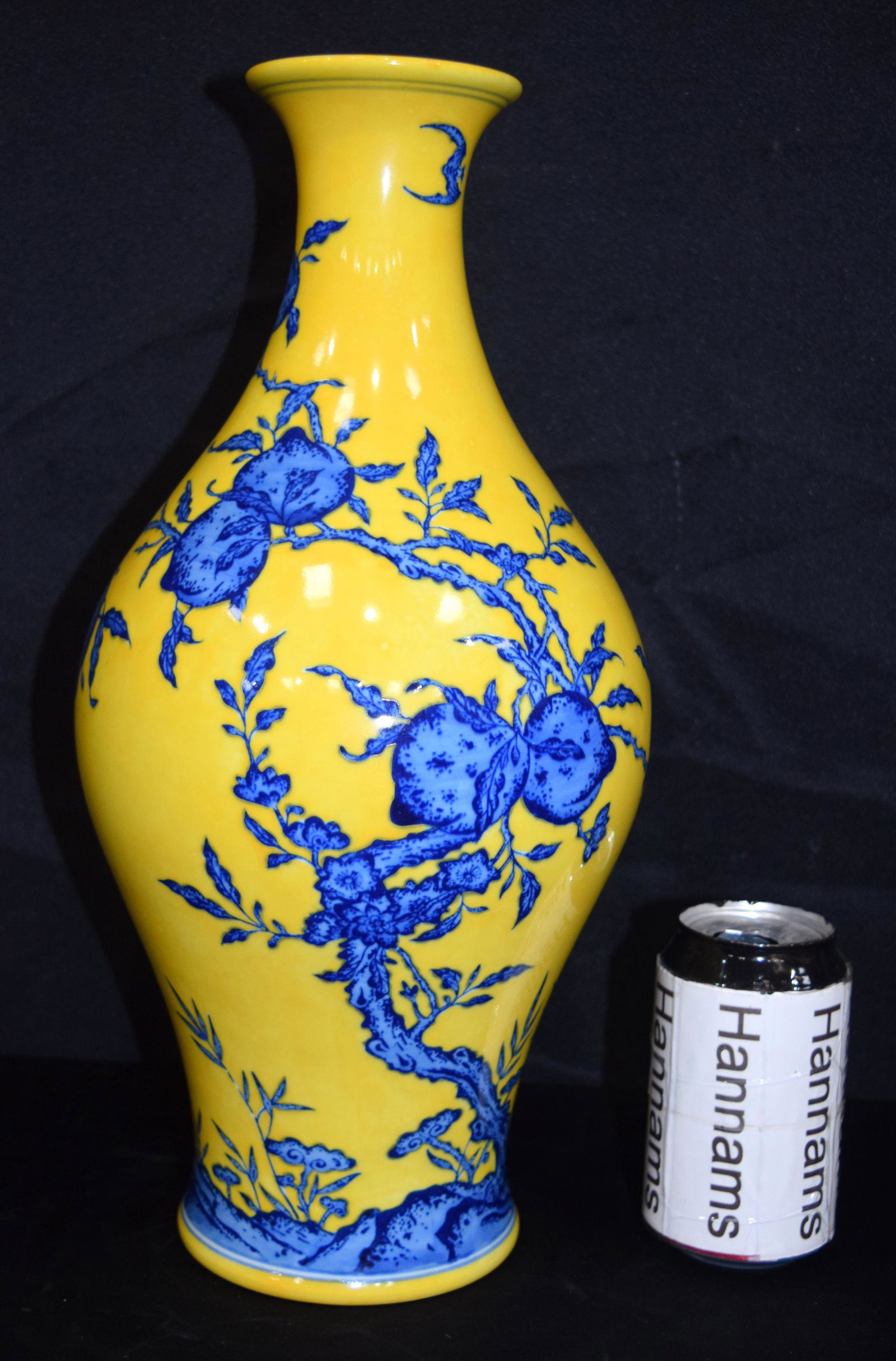 A Chinese porcelain yellow ground vase decorated with: A Chinese porcelain yellow ground vase decorated with peaches and bats. 40cm