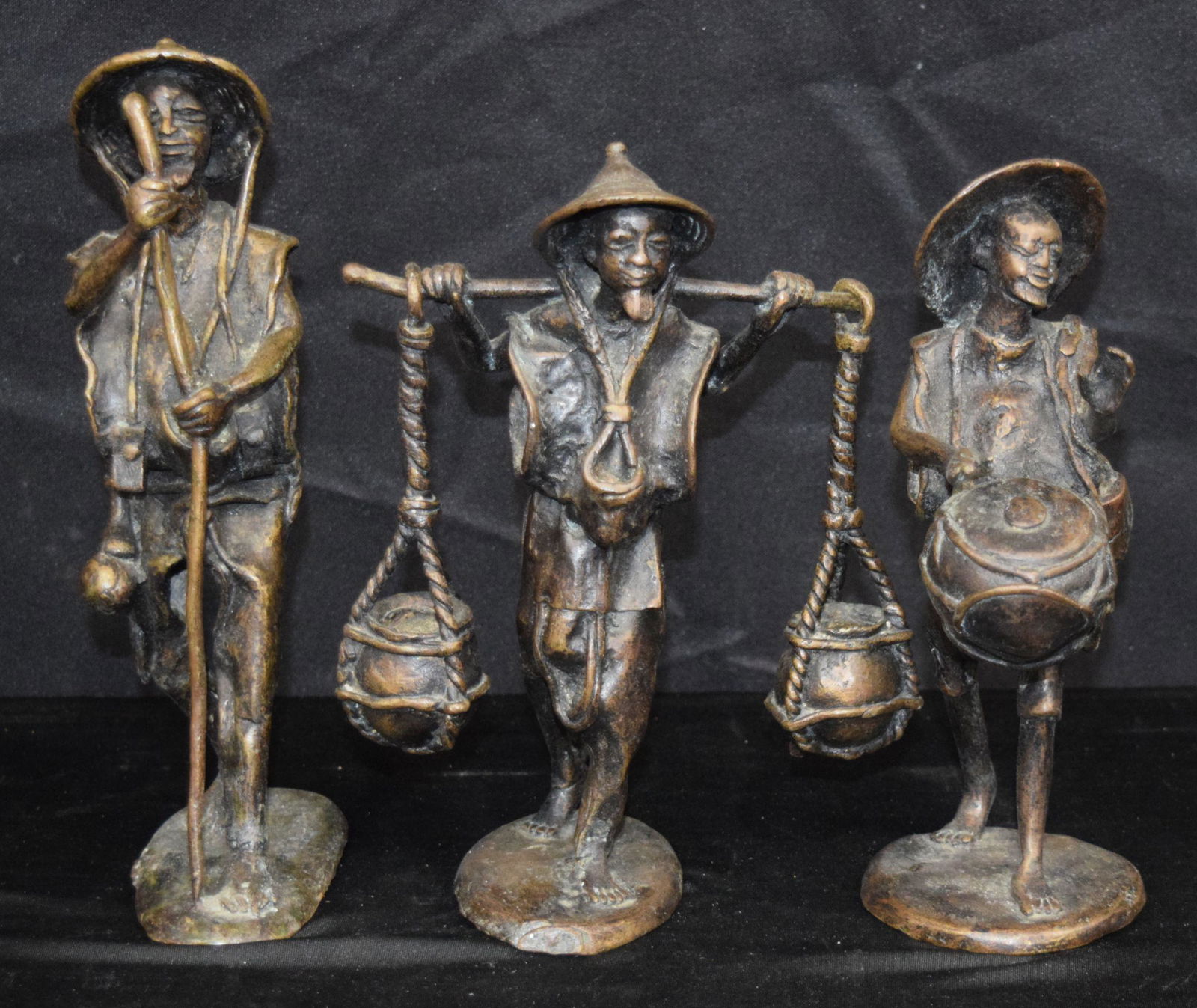 A group of three bronze South East Asian figures of (1 of 4)