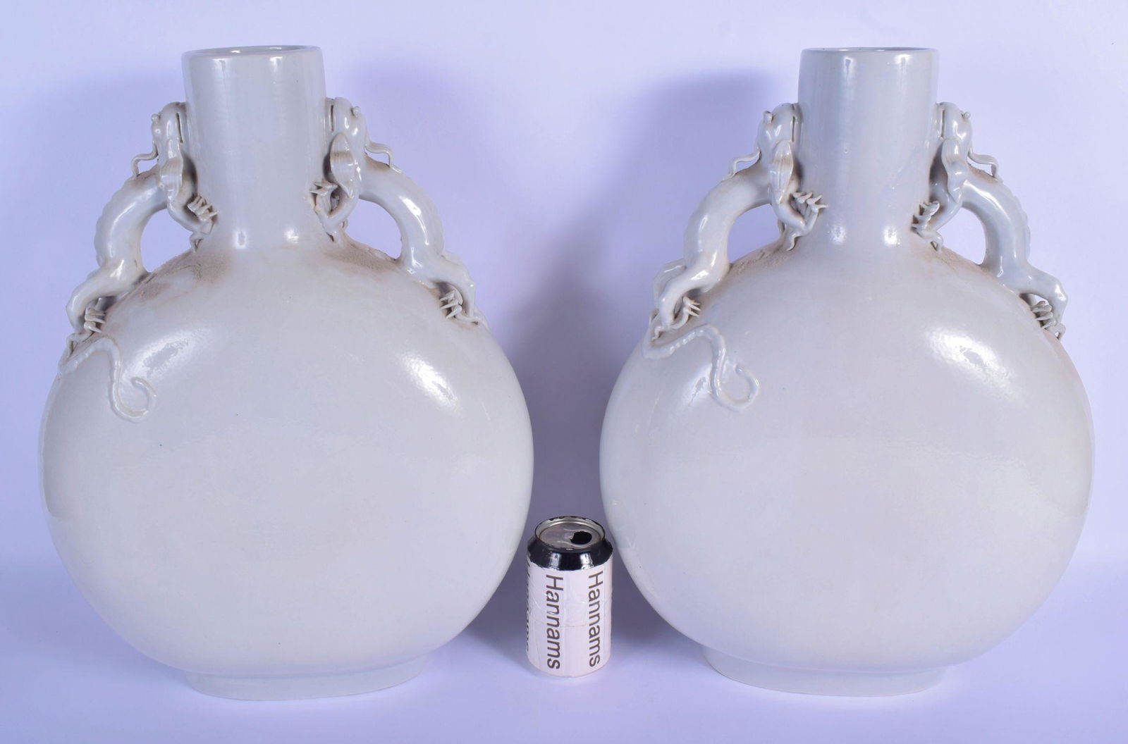 A LARGE PAIR OF EARLY 20TH CENTURY CHINESE BLANC DE: A LARGE PAIR OF EARLY 20TH CENTURY CHINESE BLANC DE CHINE PORCELAIN MOON FLASKS Late Qing/Republic, modelled with two beasts clambering up each side. 47 cm x 30 cm.
