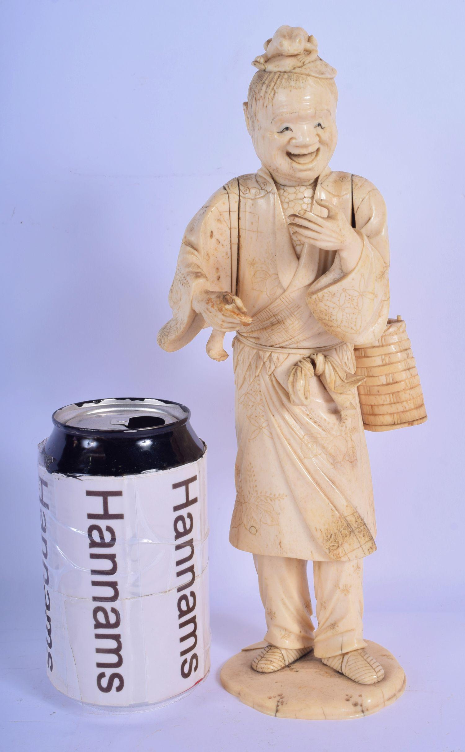 A LARGE 19TH CENTURY JAPANESE MEIJI PERIOD CARVED IVORY: A LARGE 19TH CENTURY JAPANESE MEIJI PERIOD CARVED IVORY OKIMONO modelled upon a naturalistic base. 27 m high.