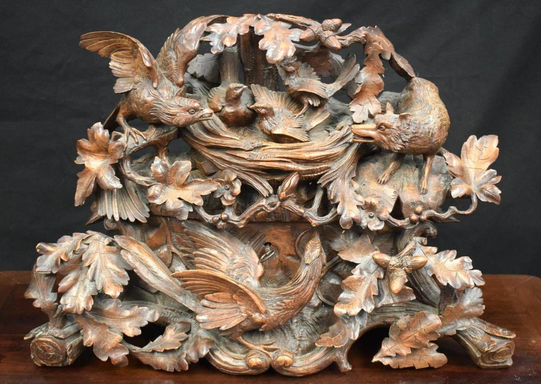 A LARGE 19TH CENTURY BARVARIAN BLACK FOREST CASKET: A LARGE 19TH CENTURY BARVARIAN BLACK FOREST CASKET DECORATED WITH BIRDS, FOXES AND ACORNS. Length 60cm, Width 24cm, Height 45cm