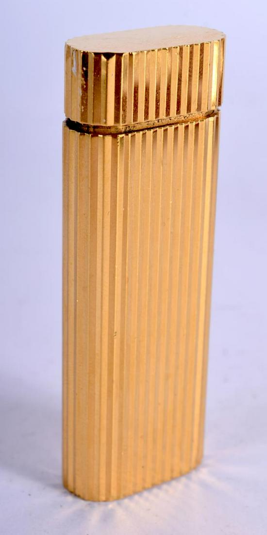 A CARTIER LIGHTER. 78.7 grams. 7 cm x 2.5 cm. (1 of 5)