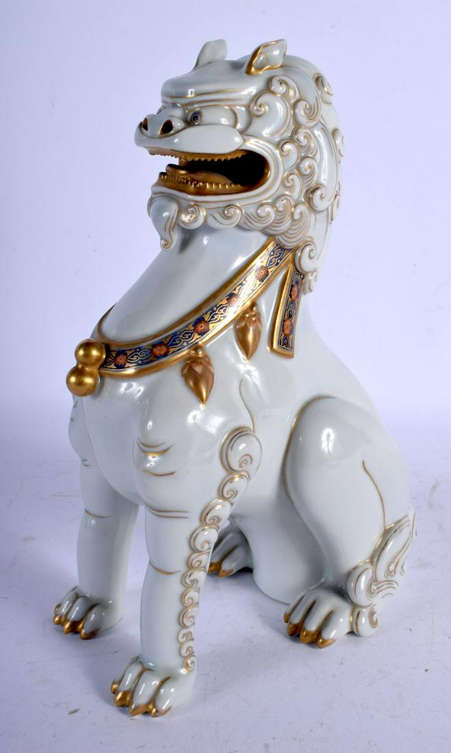 A FINE EARLY 20TH CENTURY JAPANESE MEIJI PERIOD: A FINE EARLY 20TH CENTURY JAPANESE MEIJI PERIOD PORCELAIN FIGURE OF A BUDDHISTIC LION modelled scowling. 24 cm x 12 cm.