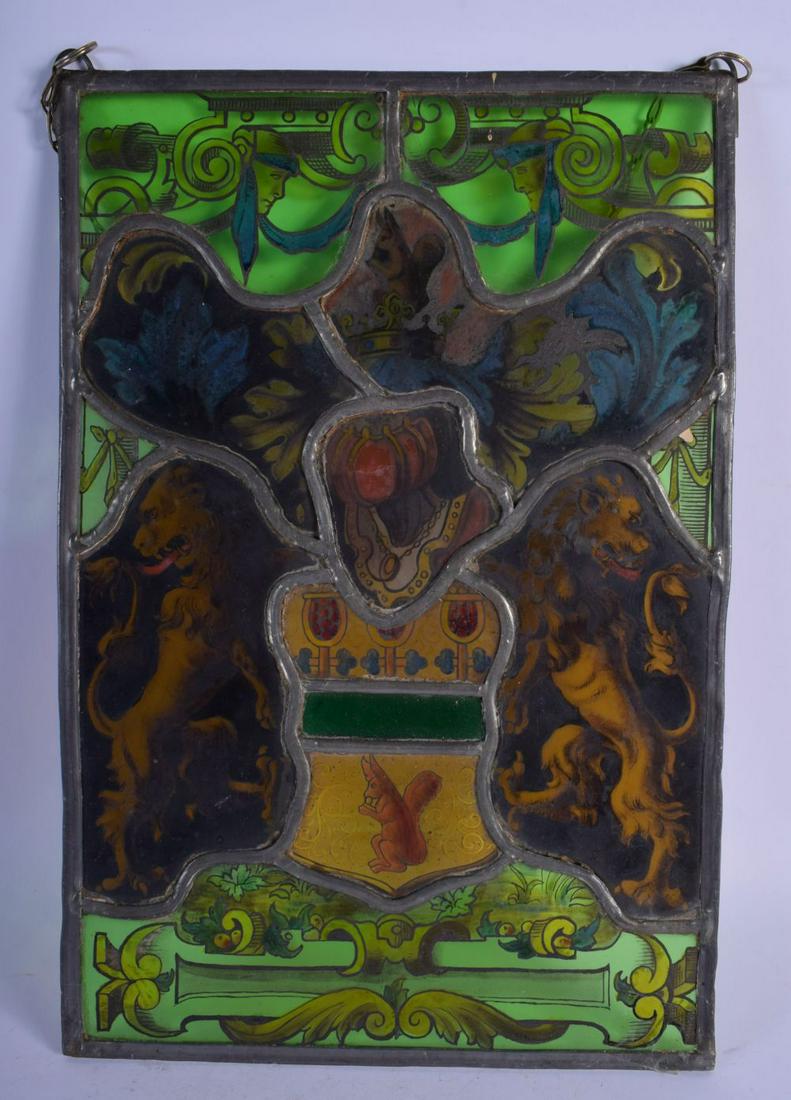 AN ANTIQUE STAINED GLASS WINDOW PANEL depicting masks, (1 of 4)