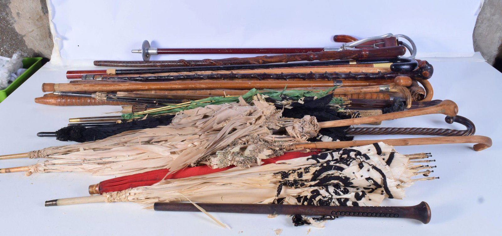 A collection of walking canes and antique parasols (1 of 5)