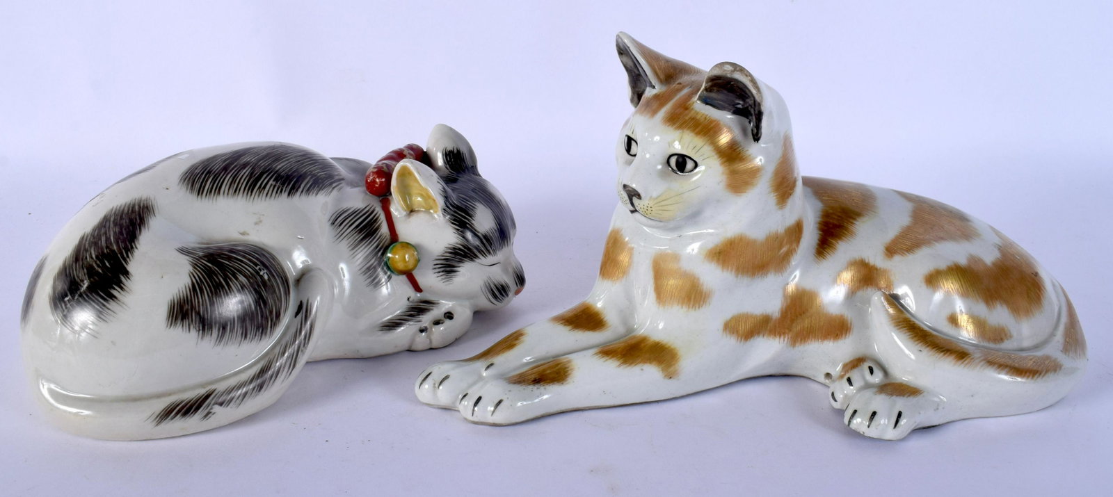 A PAIR OF 19TH CENTURY JAPANESE MEIJI PERIOD KUTANI: A PAIR OF 19TH CENTURY JAPANESE MEIJI PERIOD KUTANI FIGURES OF CATS modelled recumbent. Largest 24 cm x 15 cm.