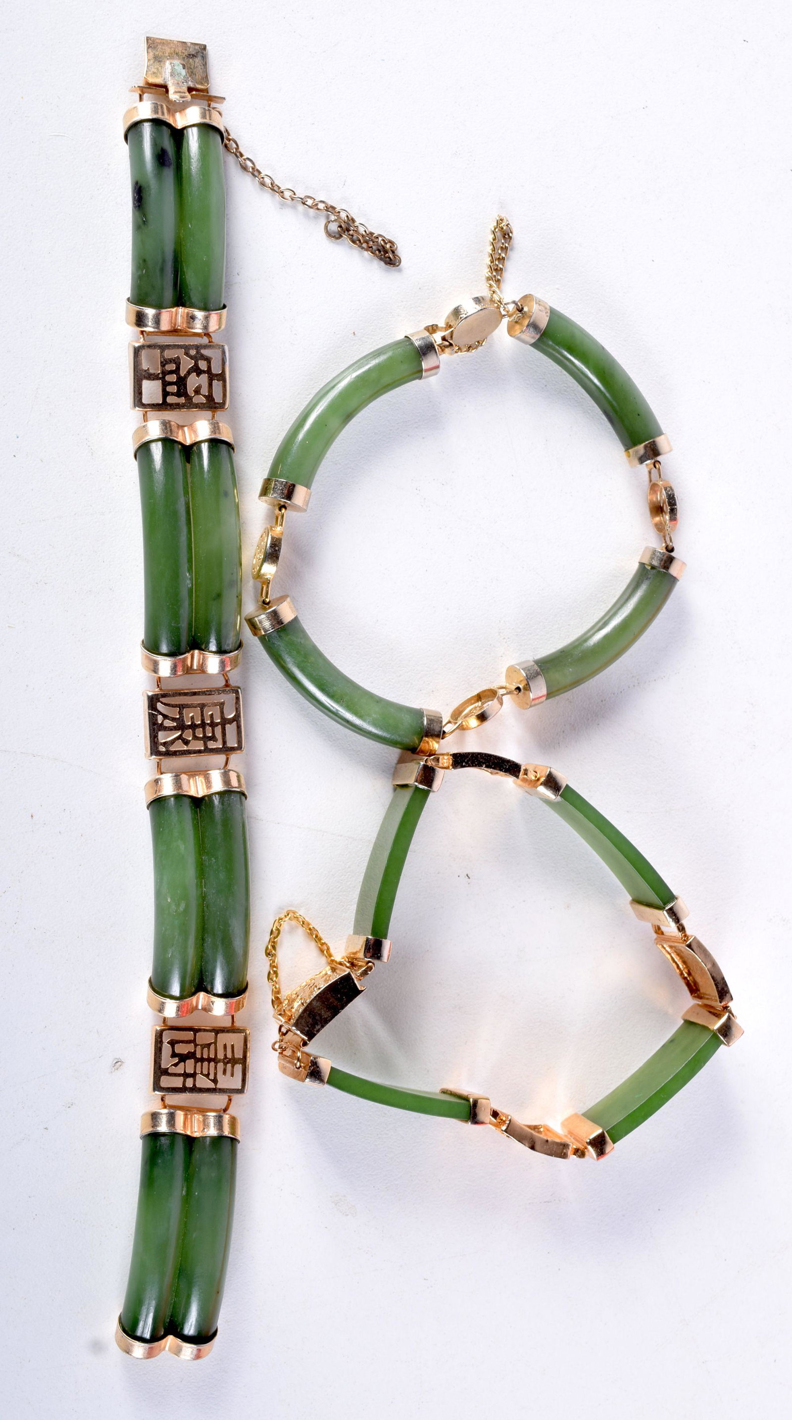 THREE JADE BRACELETS WITH YELLOW METAL MOUNTS.  Largest (1 of 4)