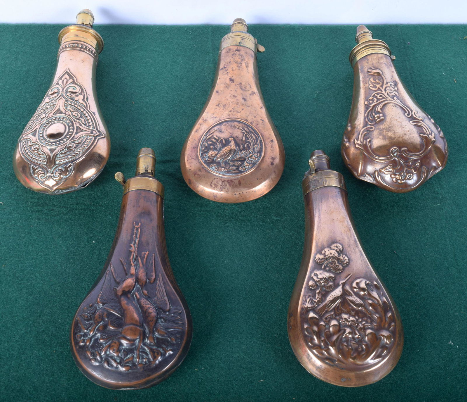 A collection of 19th Century copper, leather and Pewter: A collection of 19th Century copper, leather and Pewter powder flasks 21 cm (5)