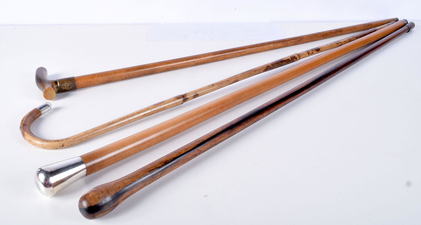 A bamboo walking cane with a silver tipped handle (1 of 3)