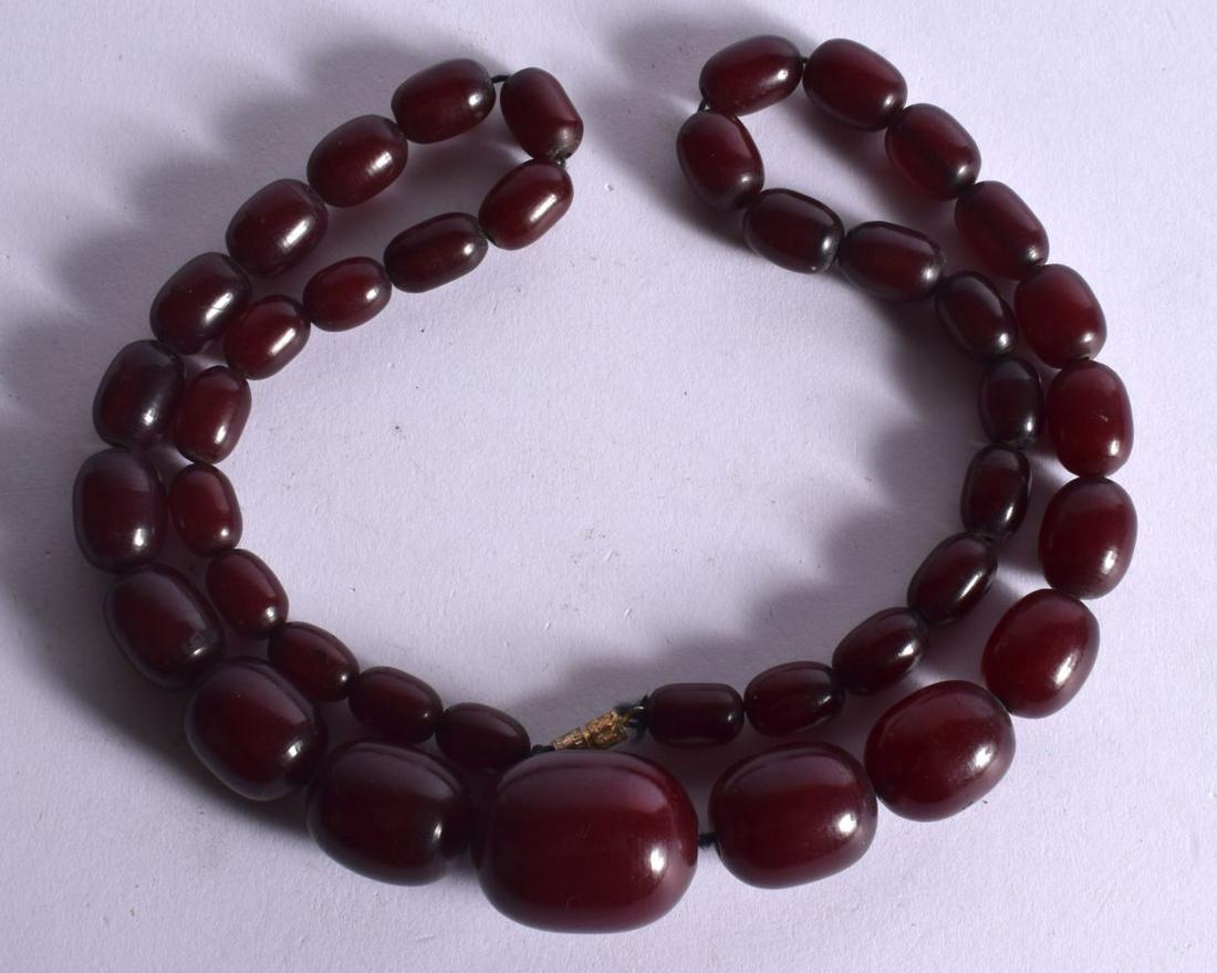 CHERRY AMBER NECKLACE.  62cm long, Largest bead 27.7mm  22.3mm, weight 63.8g (1 of 2)
