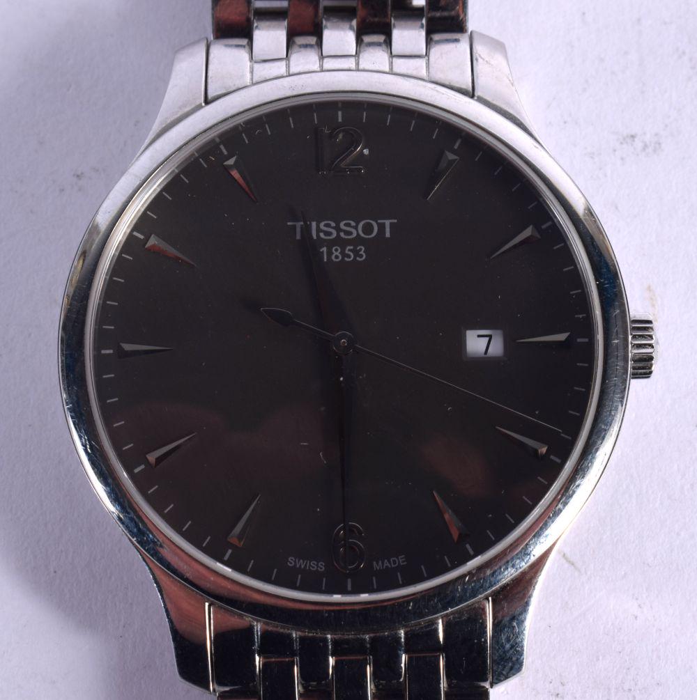 A TISSOT TRADITION MEN~S WATCH WITH AN ELEGANT STAINLESS STEEL BRACELET AND 42MM CASE, HOUSING AN AN (1 of 3)