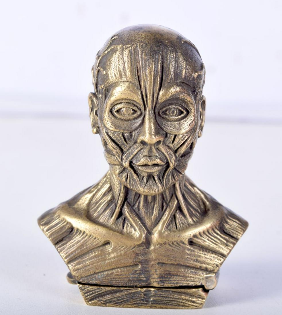 A BRASS VEST CASE IN THE FORM OF AN ANATOMICAL MAN. 5.9cm x 4.7cm, weight 72.1g: A BRASS VEST CASE IN THE FORM OF AN ANATOMICAL MAN. 5.9cm x 4.7cm, weight 72.1g