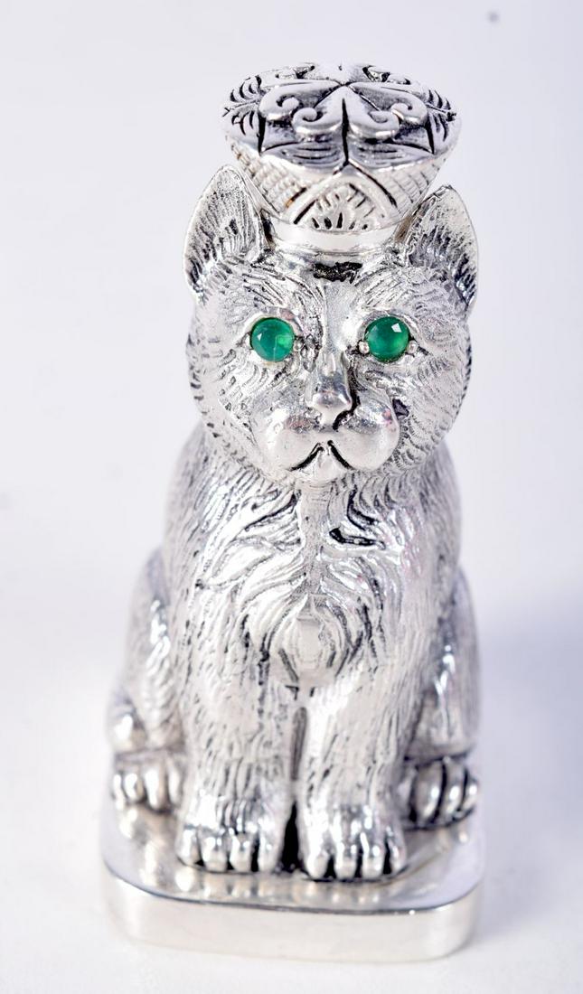 A CONTINENTAL SILVER SCENT BOTTLE IN THE FORM OF A CAT WITH A CROWN WITH JEWELLED EYES.  Stamped 84, (1 of 3)